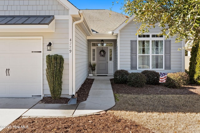 doorway to property with a garage