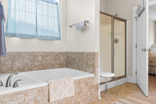 bathroom with shower with separate bathtub and tile patterned floors