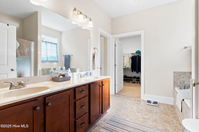 bathroom with vanity, tile patterned flooring, and a tub