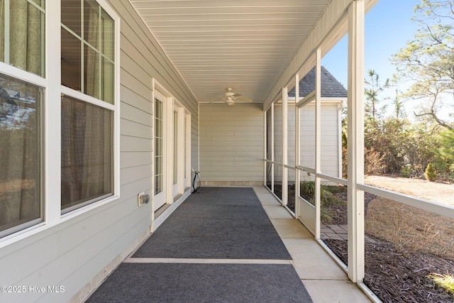 unfurnished sunroom featuring ceiling fan