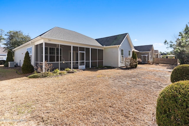 rear view of property featuring a sunroom and central air condition unit