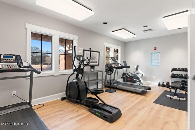 workout area with hardwood / wood-style floors