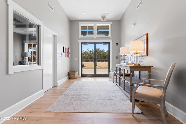 entryway with light hardwood / wood-style floors and french doors