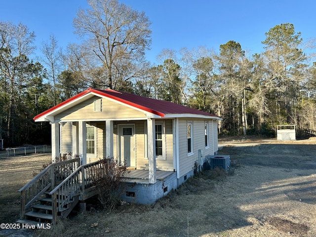 view of front facade with central AC and covered porch