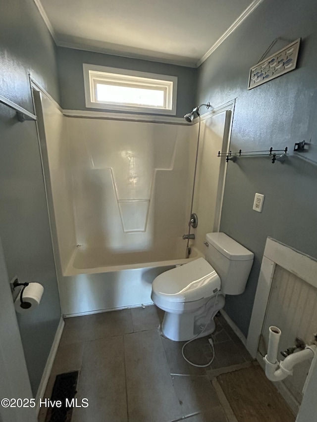 bathroom featuring shower / washtub combination, tile patterned floors, crown molding, and toilet