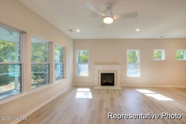 unfurnished living room with ceiling fan and light hardwood / wood-style flooring