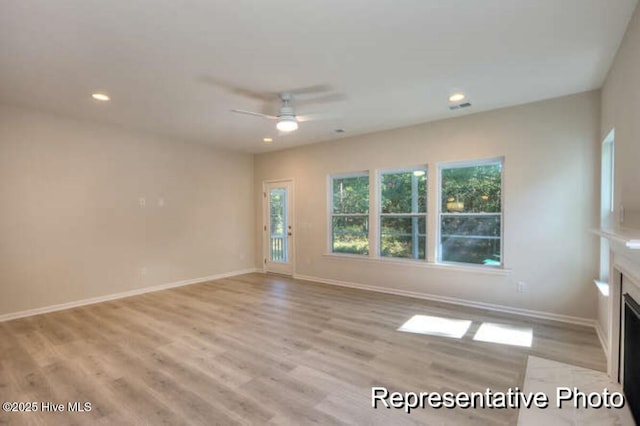 spare room with ceiling fan and light hardwood / wood-style flooring