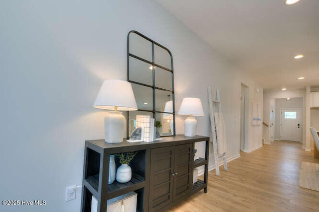 corridor with recessed lighting, light wood-style flooring, and baseboards