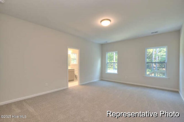 unfurnished room with light carpet