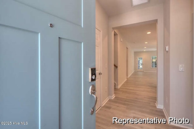 corridor with light hardwood / wood-style floors