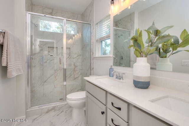 bathroom with marble finish floor, a sink, and a marble finish shower