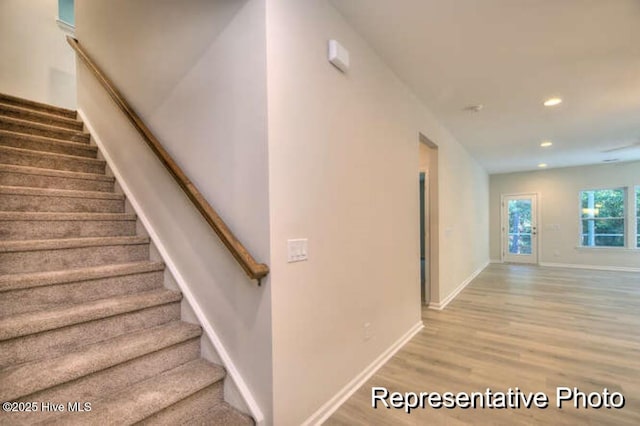 stairs featuring hardwood / wood-style floors