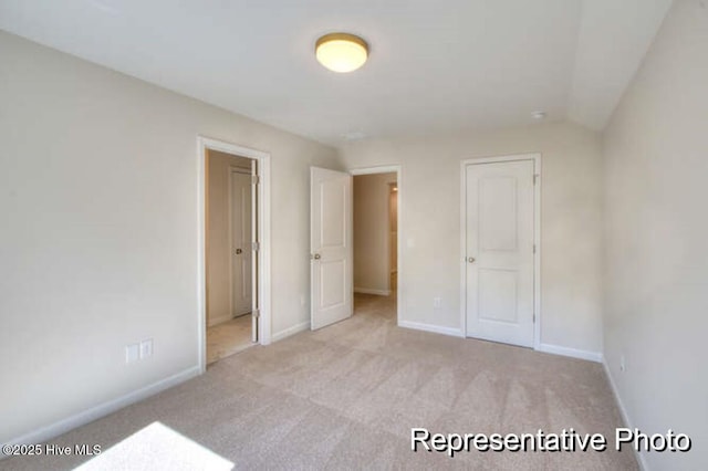 unfurnished bedroom with light colored carpet