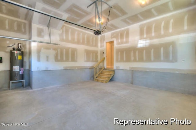 garage with a garage door opener and water heater