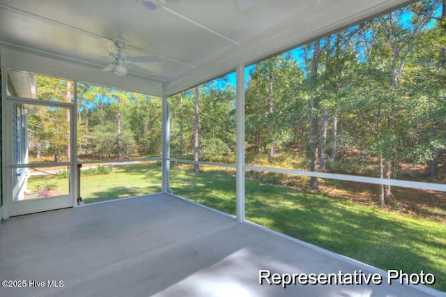 unfurnished sunroom featuring ceiling fan