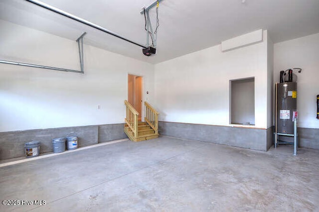 garage with water heater and a garage door opener