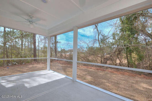 unfurnished sunroom featuring ceiling fan