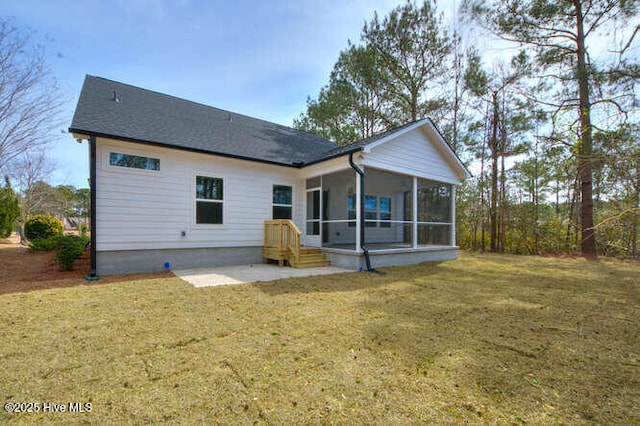 back of property featuring a lawn and a sunroom