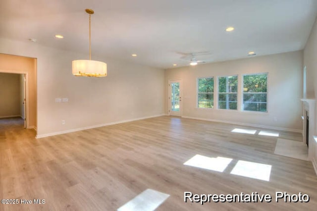 spare room with ceiling fan and light hardwood / wood-style floors