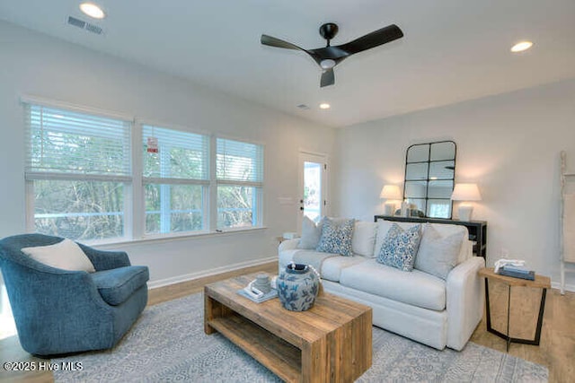 living area with recessed lighting, visible vents, ceiling fan, and wood finished floors