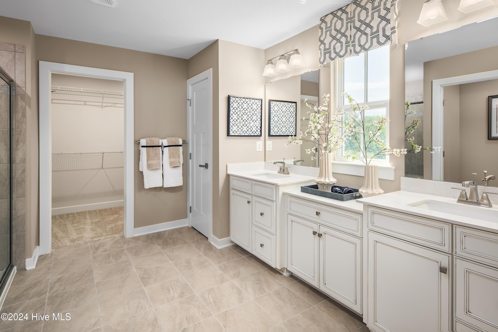 bathroom with vanity and a shower with door