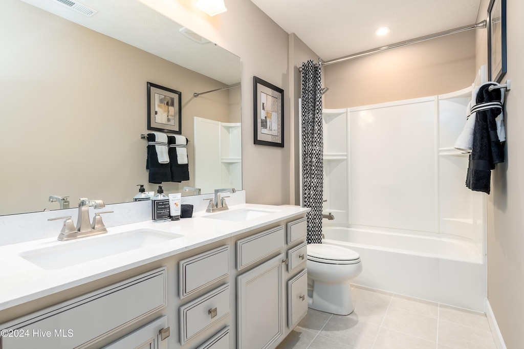 full bathroom with tile patterned flooring, vanity, shower / bathtub combination with curtain, and toilet