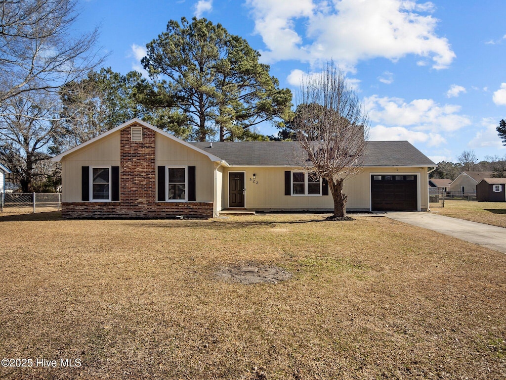 ranch-style home with a garage and a front yard