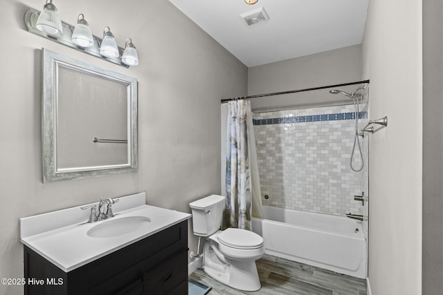 full bathroom with shower / bath combo, hardwood / wood-style floors, vanity, and toilet