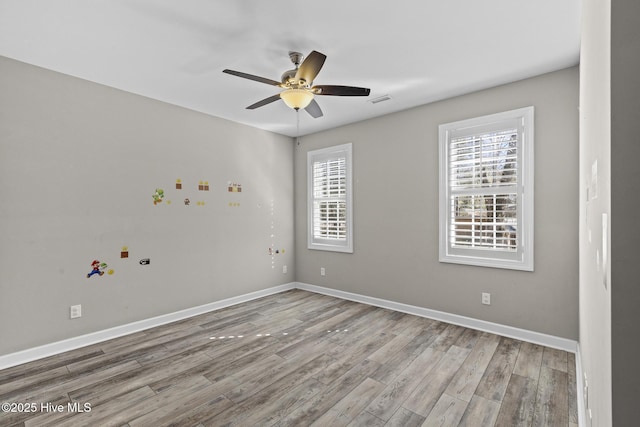 spare room with hardwood / wood-style flooring and ceiling fan