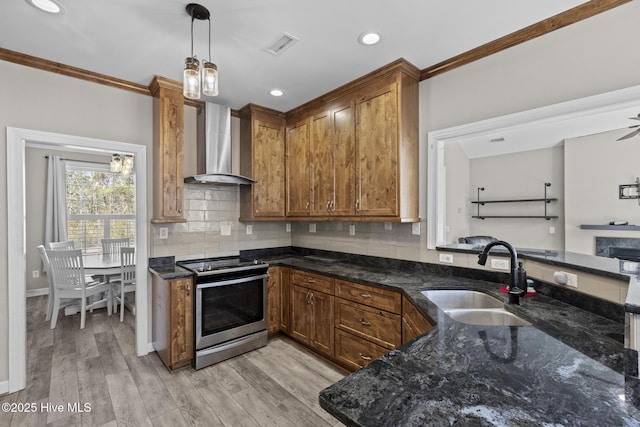 kitchen with sink, stainless steel electric range oven, hanging light fixtures, decorative backsplash, and wall chimney range hood