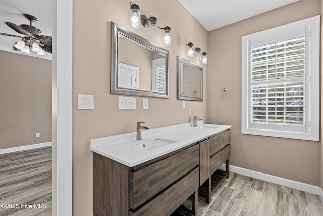 bathroom featuring hardwood / wood-style flooring, ceiling fan, and vanity