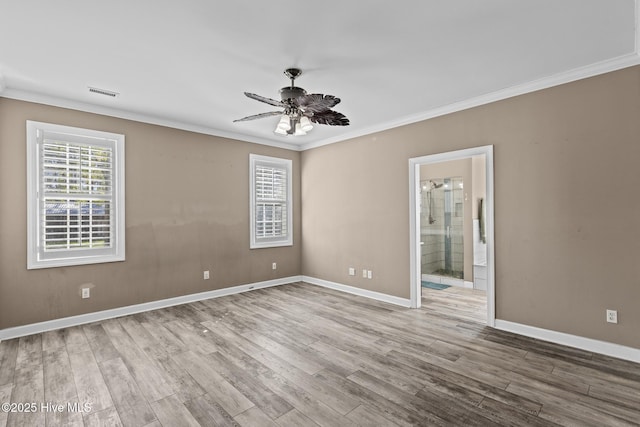 spare room featuring crown molding, ceiling fan, and light hardwood / wood-style floors