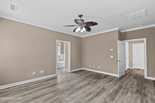 spare room featuring crown molding, hardwood / wood-style floors, and ceiling fan