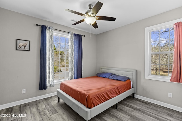 bedroom with hardwood / wood-style floors and ceiling fan