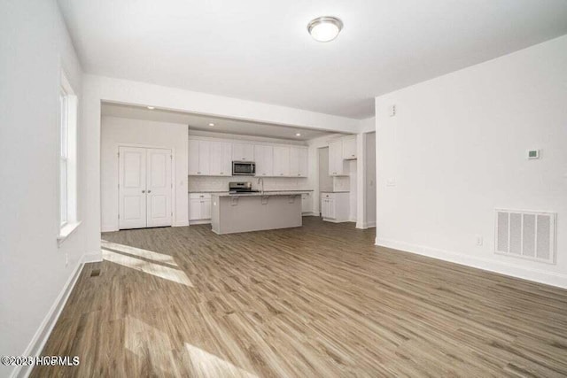 unfurnished living room featuring light hardwood / wood-style flooring