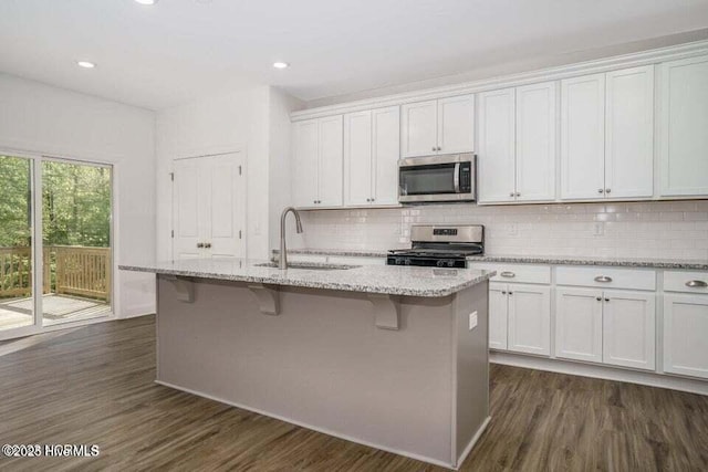 kitchen featuring sink, a center island with sink, white cabinets, and appliances with stainless steel finishes