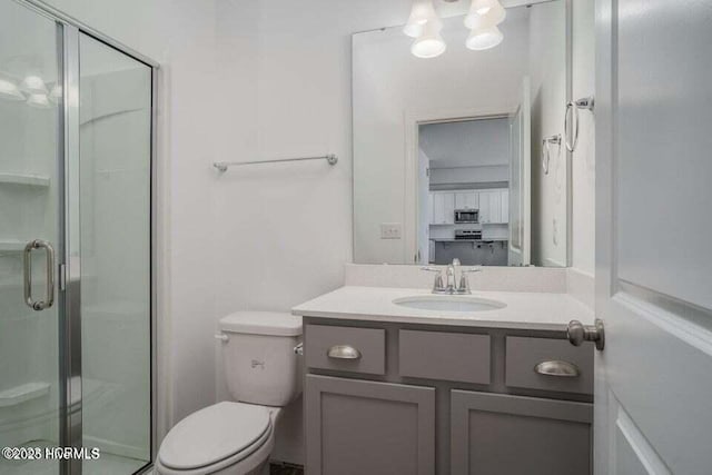 bathroom with vanity, toilet, and walk in shower