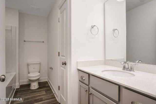 bathroom with hardwood / wood-style flooring, vanity, and toilet