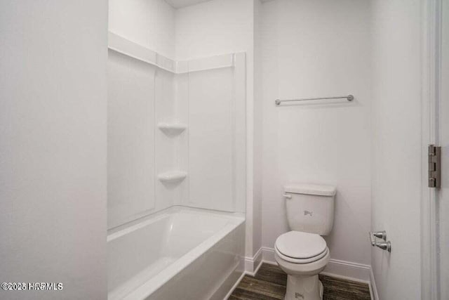 bathroom featuring wood-type flooring, toilet, and shower / bathing tub combination