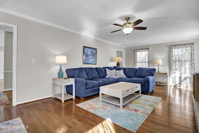 living room with dark wood-type flooring, ornamental molding, and a textured ceiling