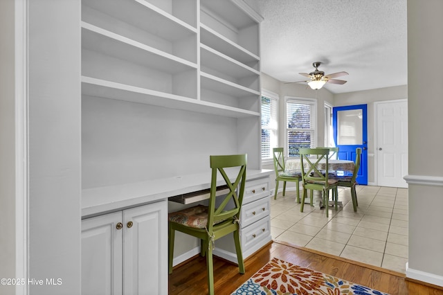 office area featuring ceiling fan, light hardwood / wood-style flooring, and a textured ceiling