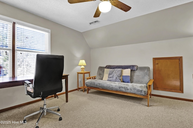 carpeted office space with lofted ceiling, ceiling fan, and a textured ceiling