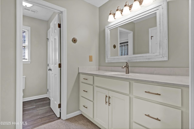 bathroom with hardwood / wood-style flooring and vanity