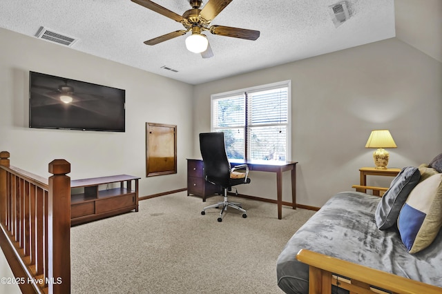 office space featuring ceiling fan, carpet, and a textured ceiling