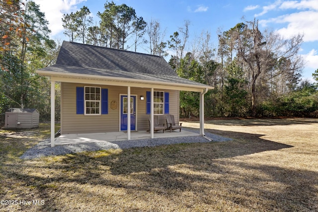 view of front of house featuring a storage shed and a patio