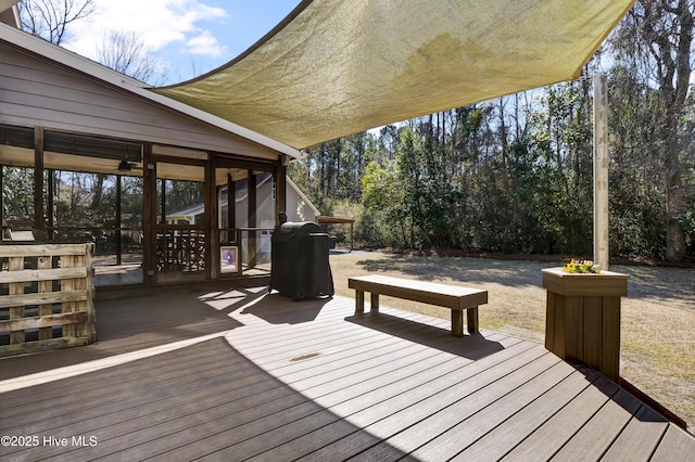 deck featuring a sunroom and grilling area