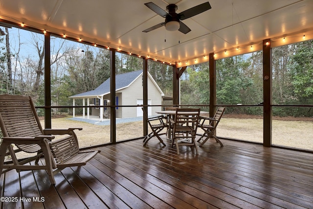 sunroom / solarium featuring ceiling fan