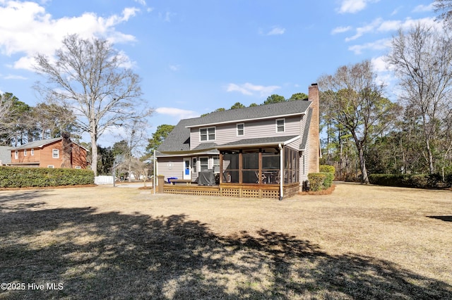 back of property featuring a deck and a sunroom