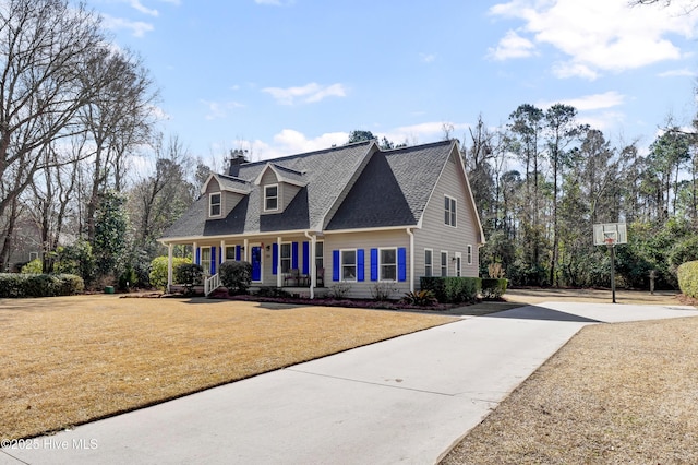 cape cod house featuring covered porch and a front lawn