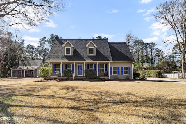 new england style home featuring a front lawn